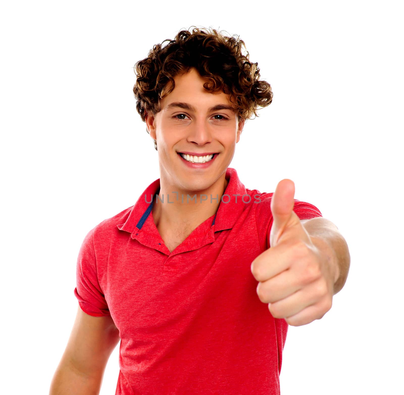 Handsome young man gesturing thumbs-up isolated on white