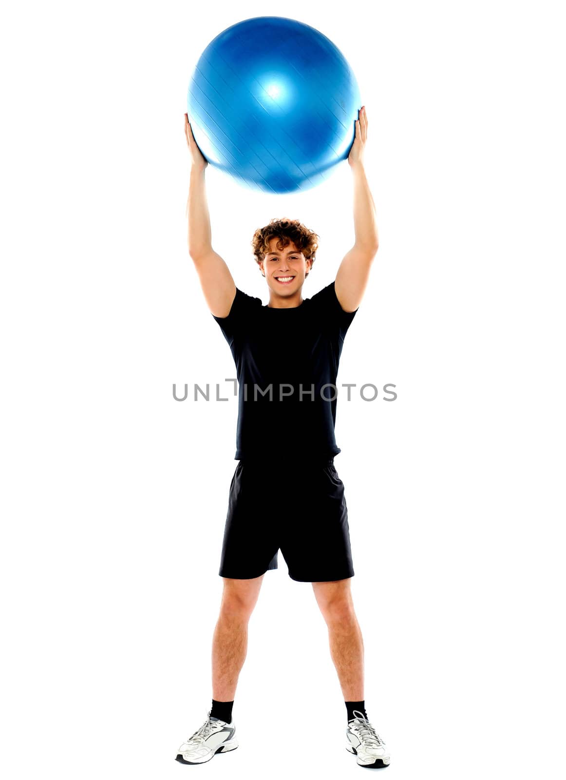 Man showing big ball over his head. Facing camera