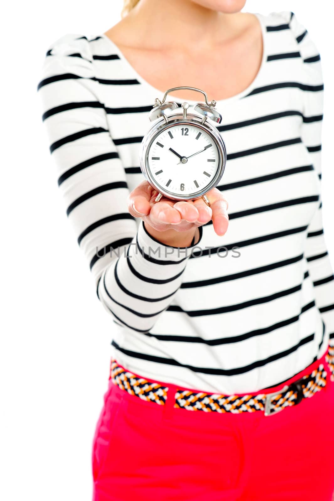 Cropped image of a woman holding alarm clock. Focus on clock