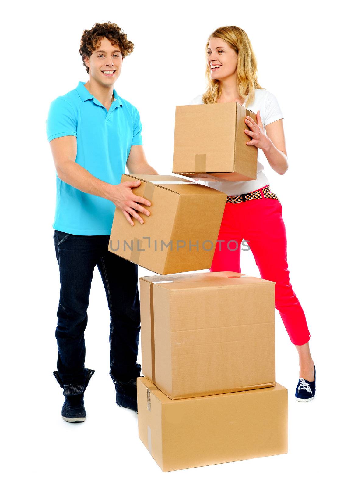 A young couple holds boxes in studio. White background