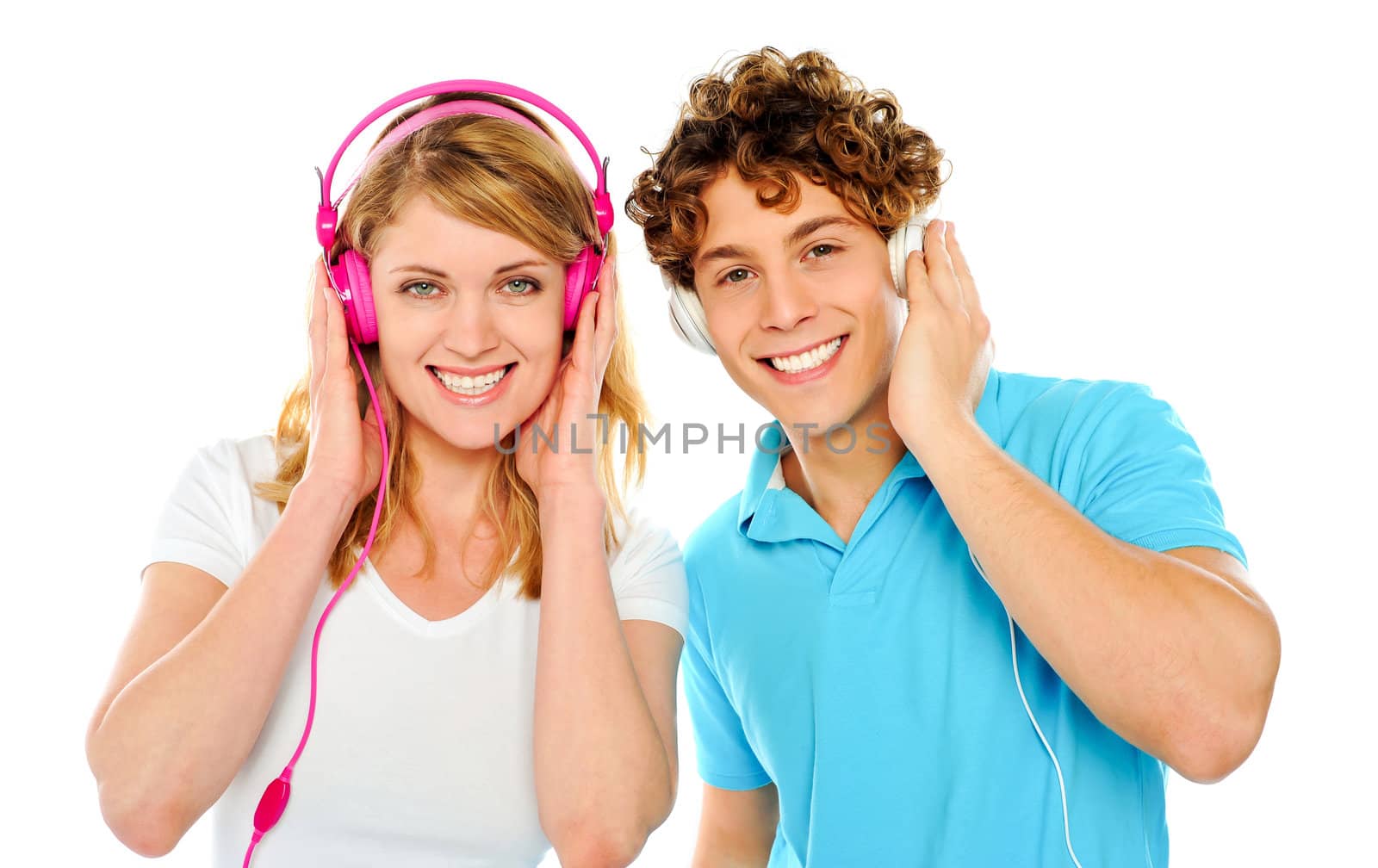 Couple enjoying music through headphones isolate over white