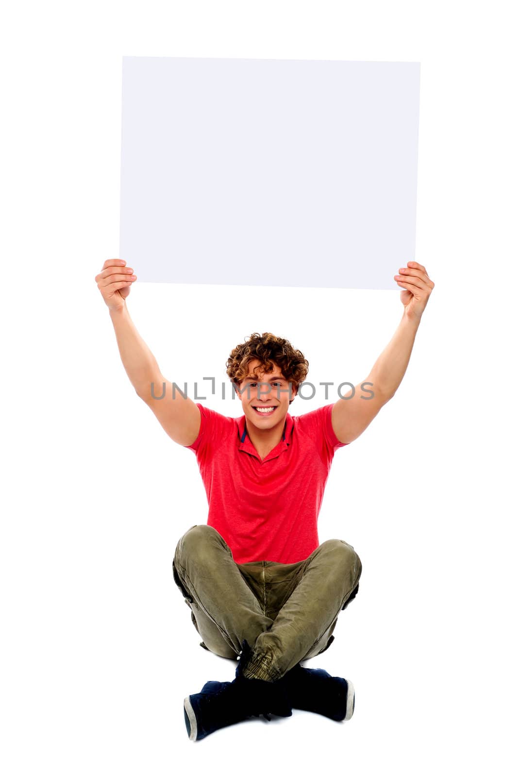 Trendy guy sitting with crossed legs holding white clipboard