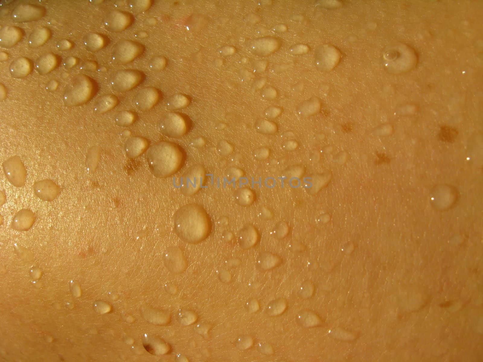 the surface of a human skin with droplets of water