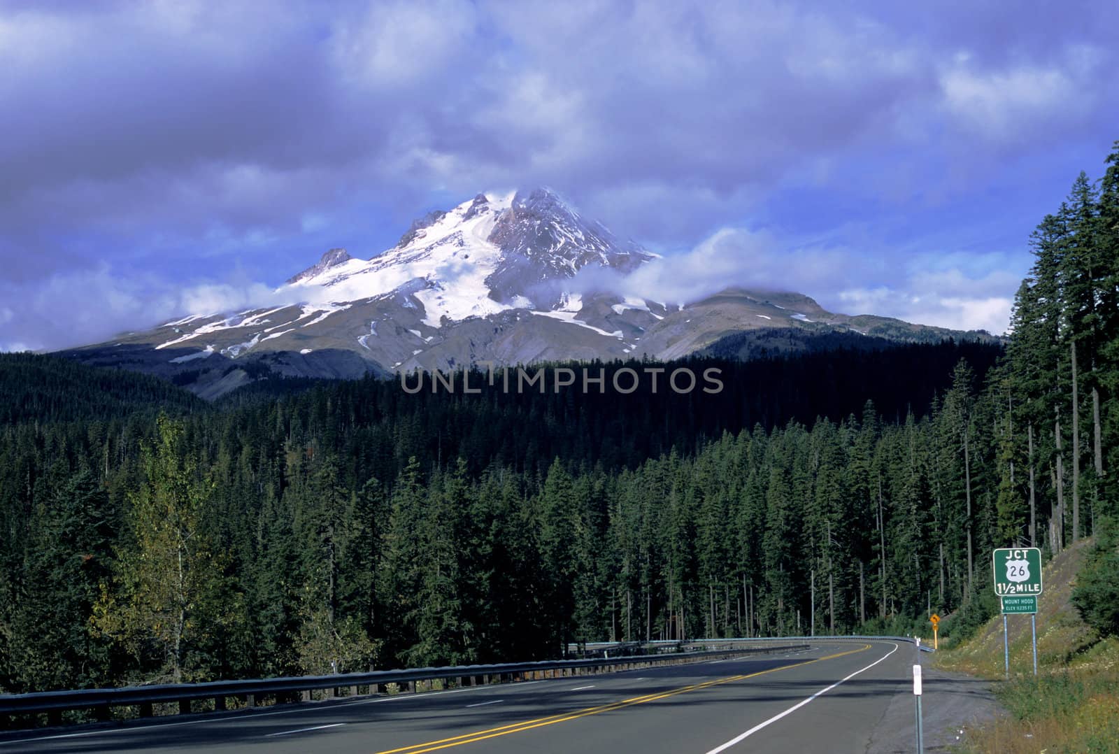 The peak of majestic Mount Hood pokes through the clouds in northwest Oregon.