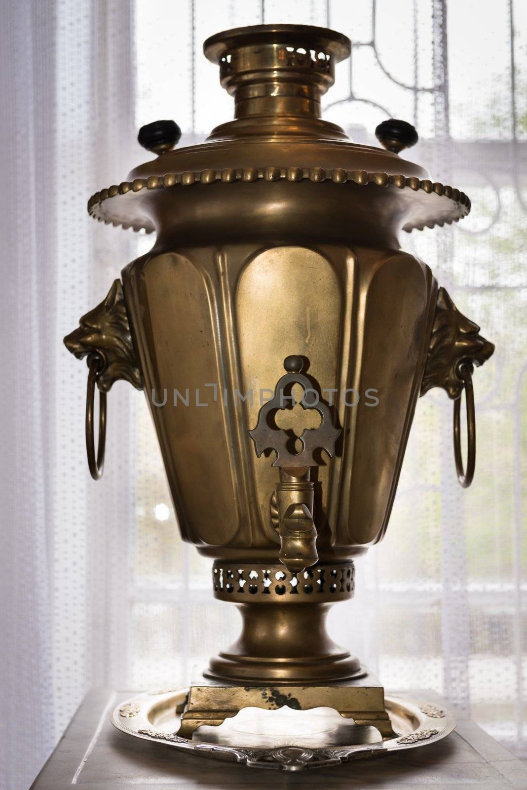 Traditional russian samovar with lions heads and selective focus on the front handle