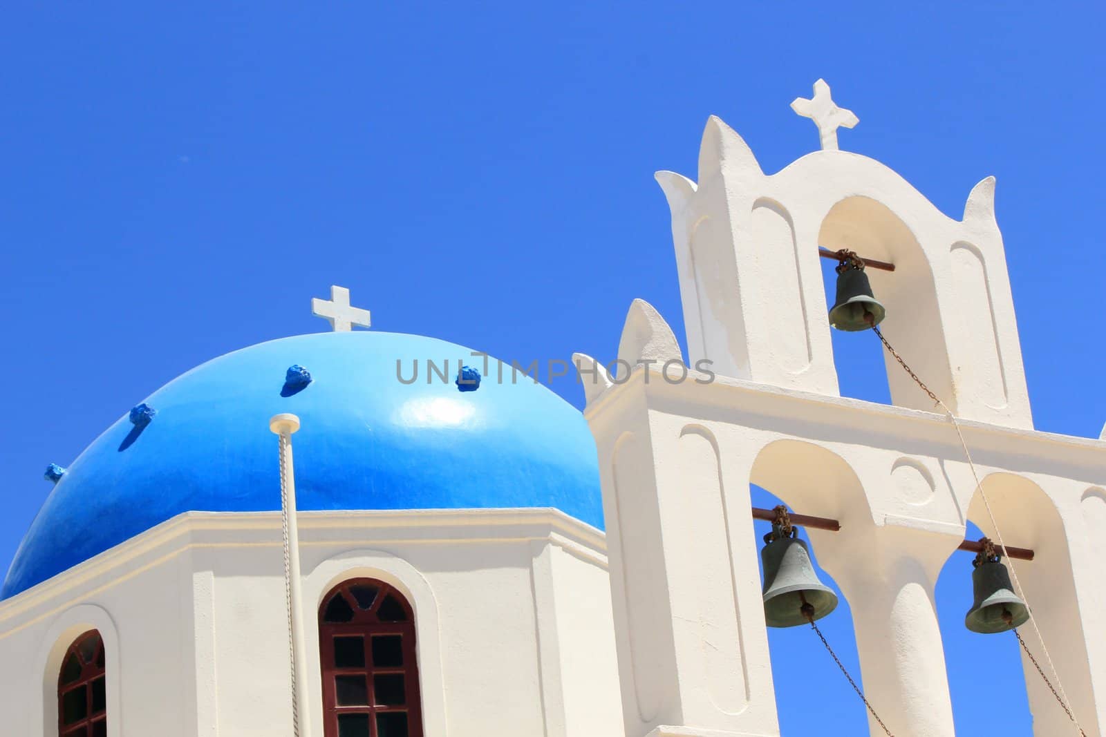 Close up of the blue dome and belfry of a church at Oia, Santorini, Greece, by beautiful weather