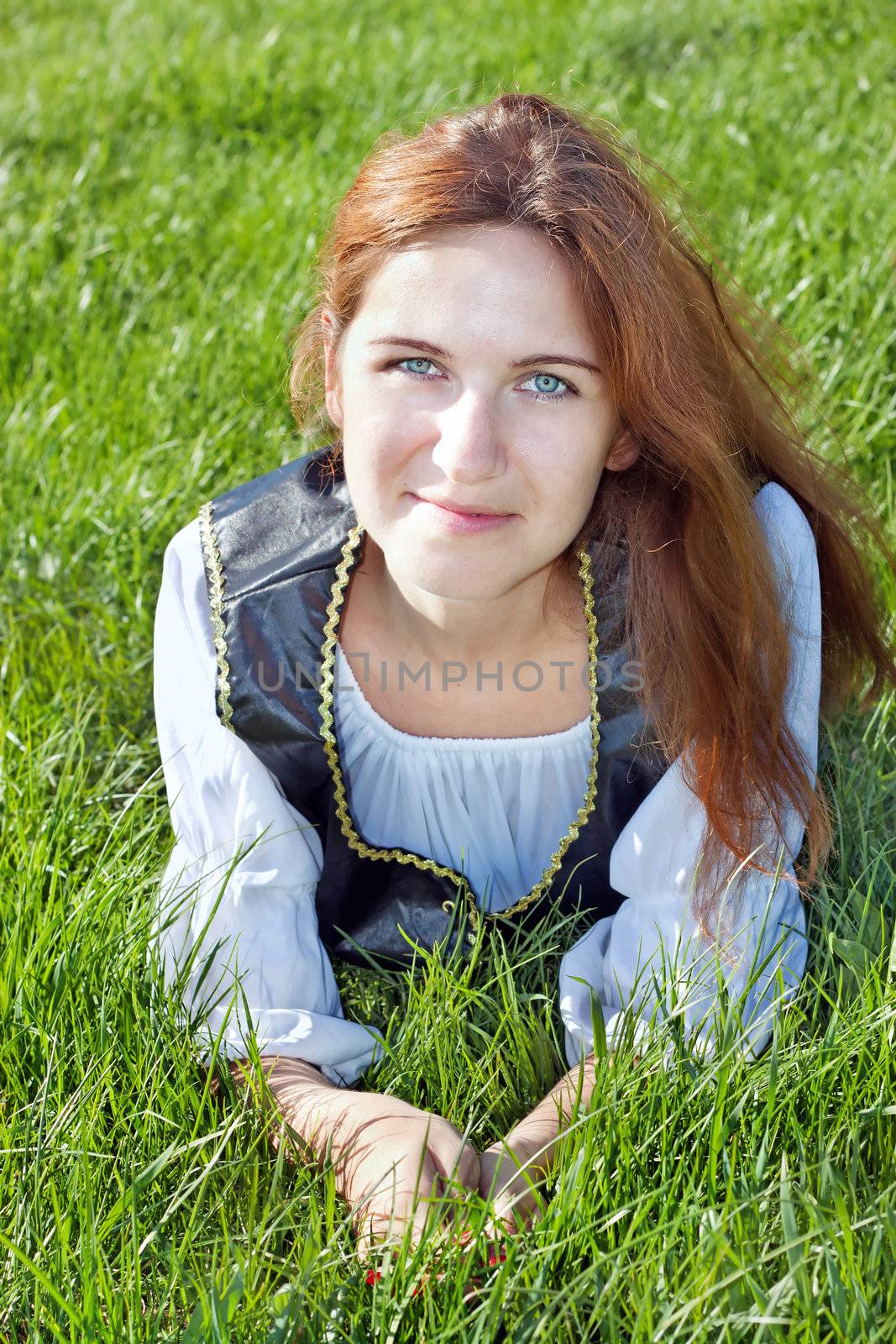 Medieval woman laying on the grass
