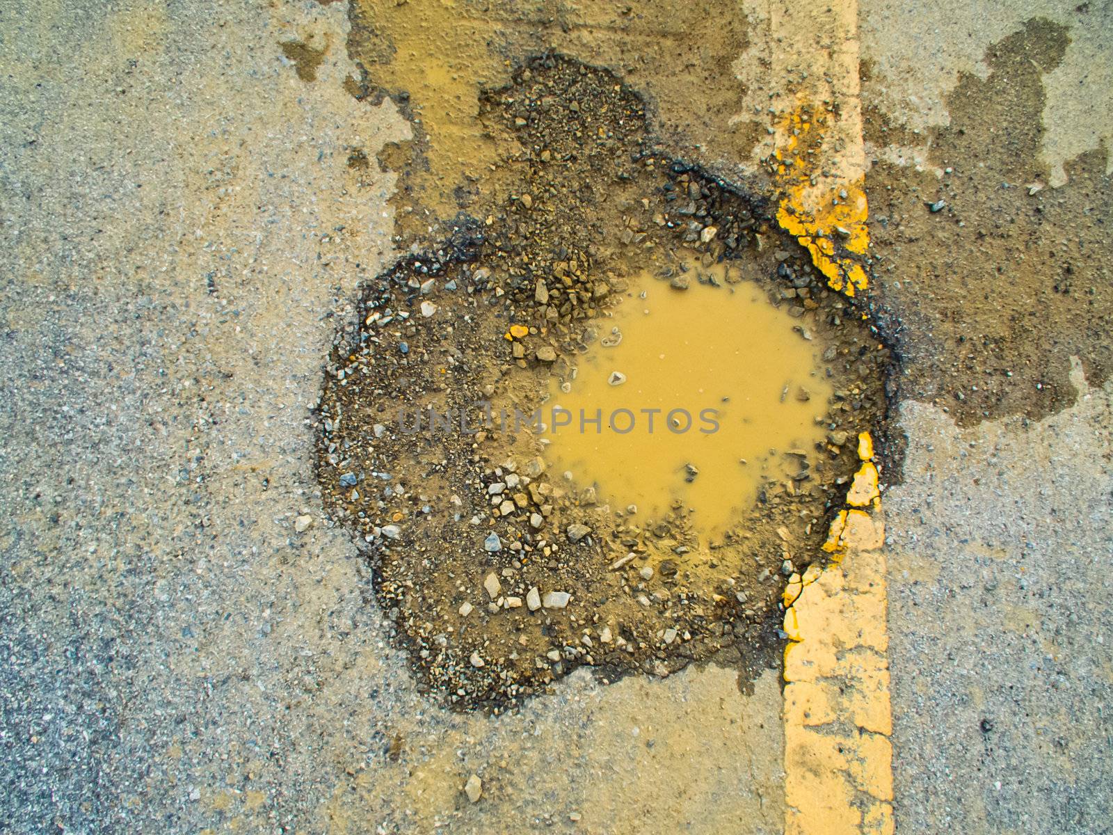 the asphalt road collapsed because of erosion.