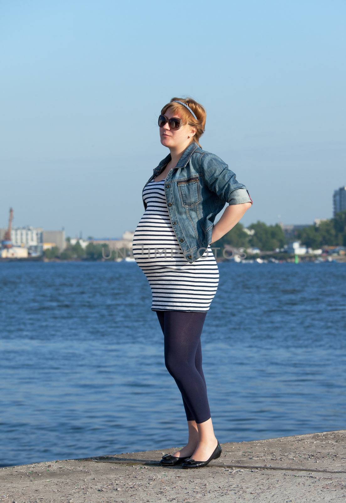 Pregnant Woman on Pier in the Urban Landscape