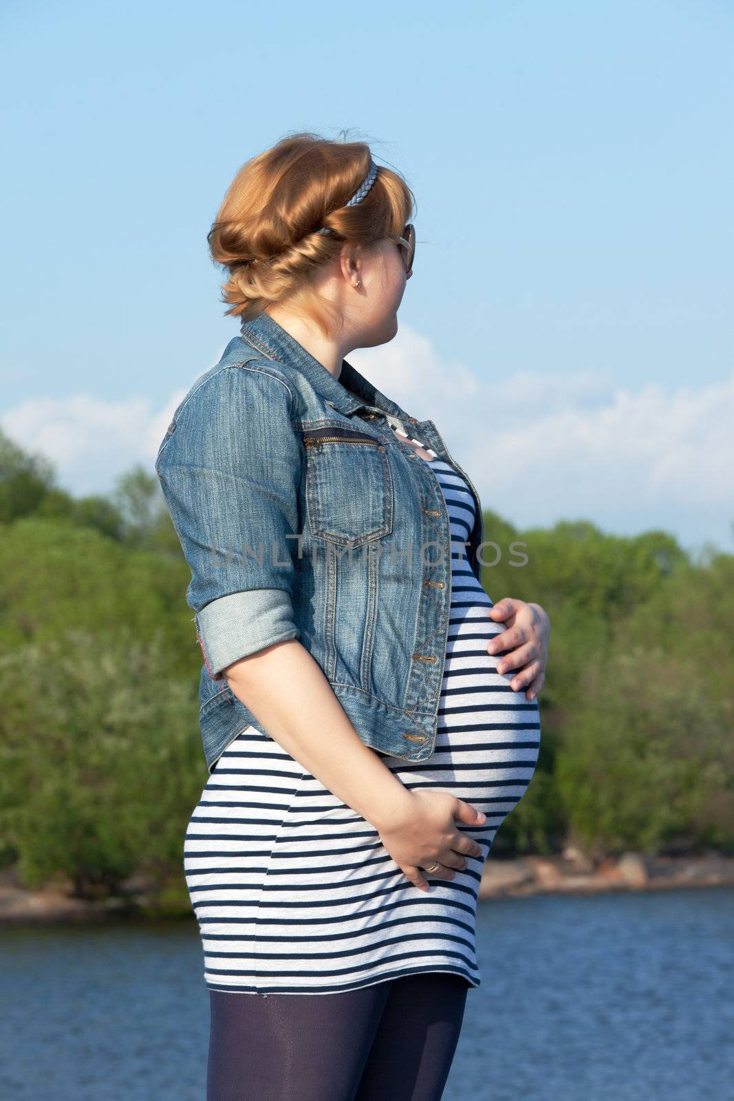 Pregnant woman on the river coast by Discovod