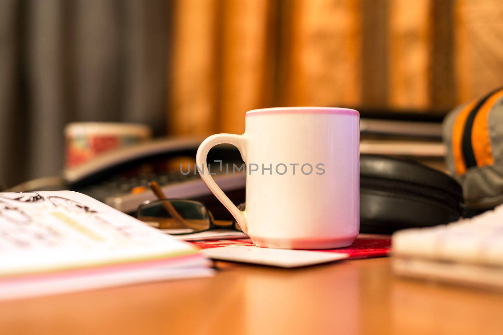 Coffee mug and blurred computer keyboard in the background.