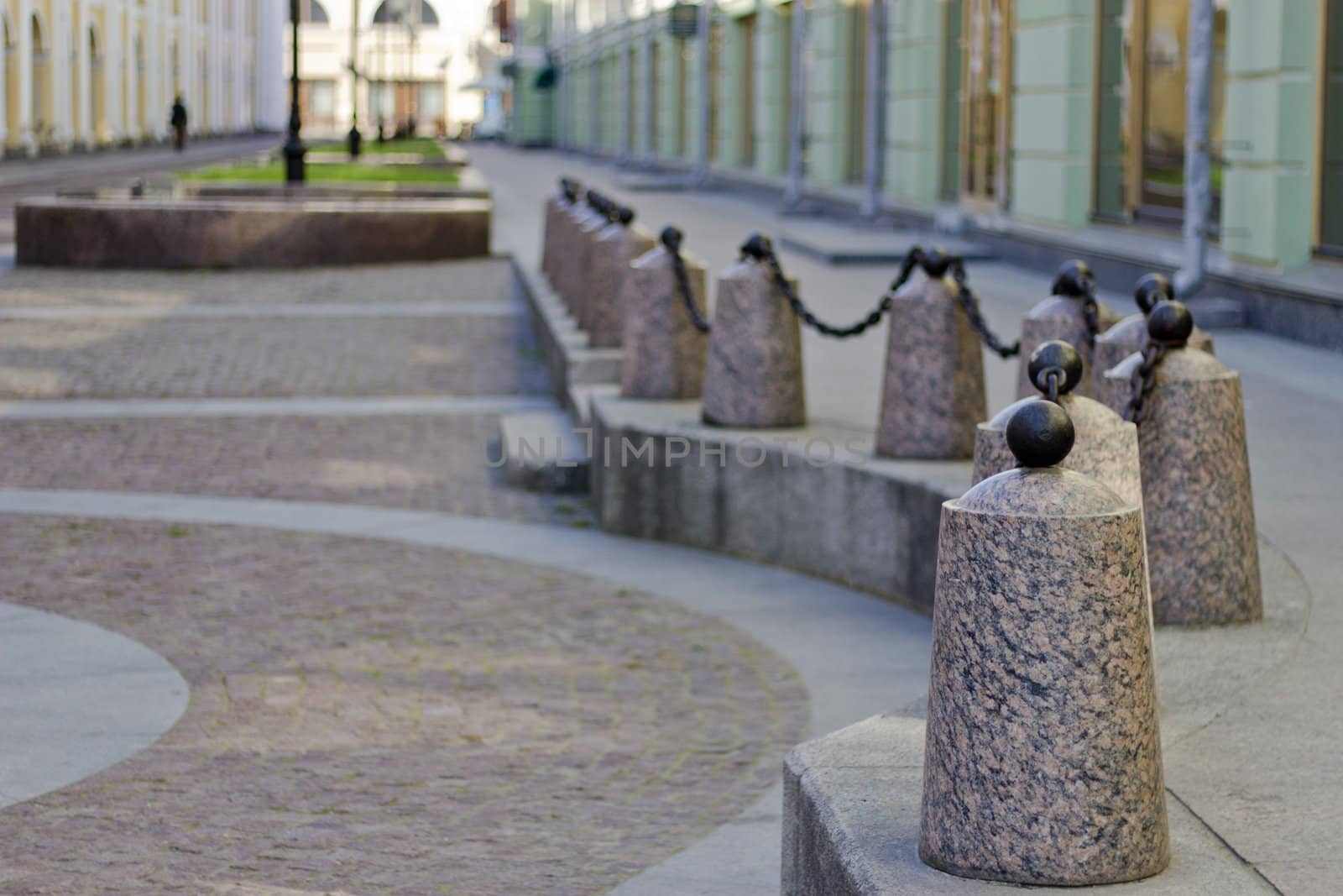 Curbstones with a chain near the ancient house