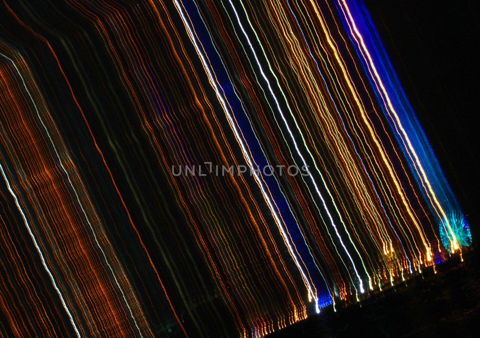 Burst of colorful striking line of lights on a jet black background