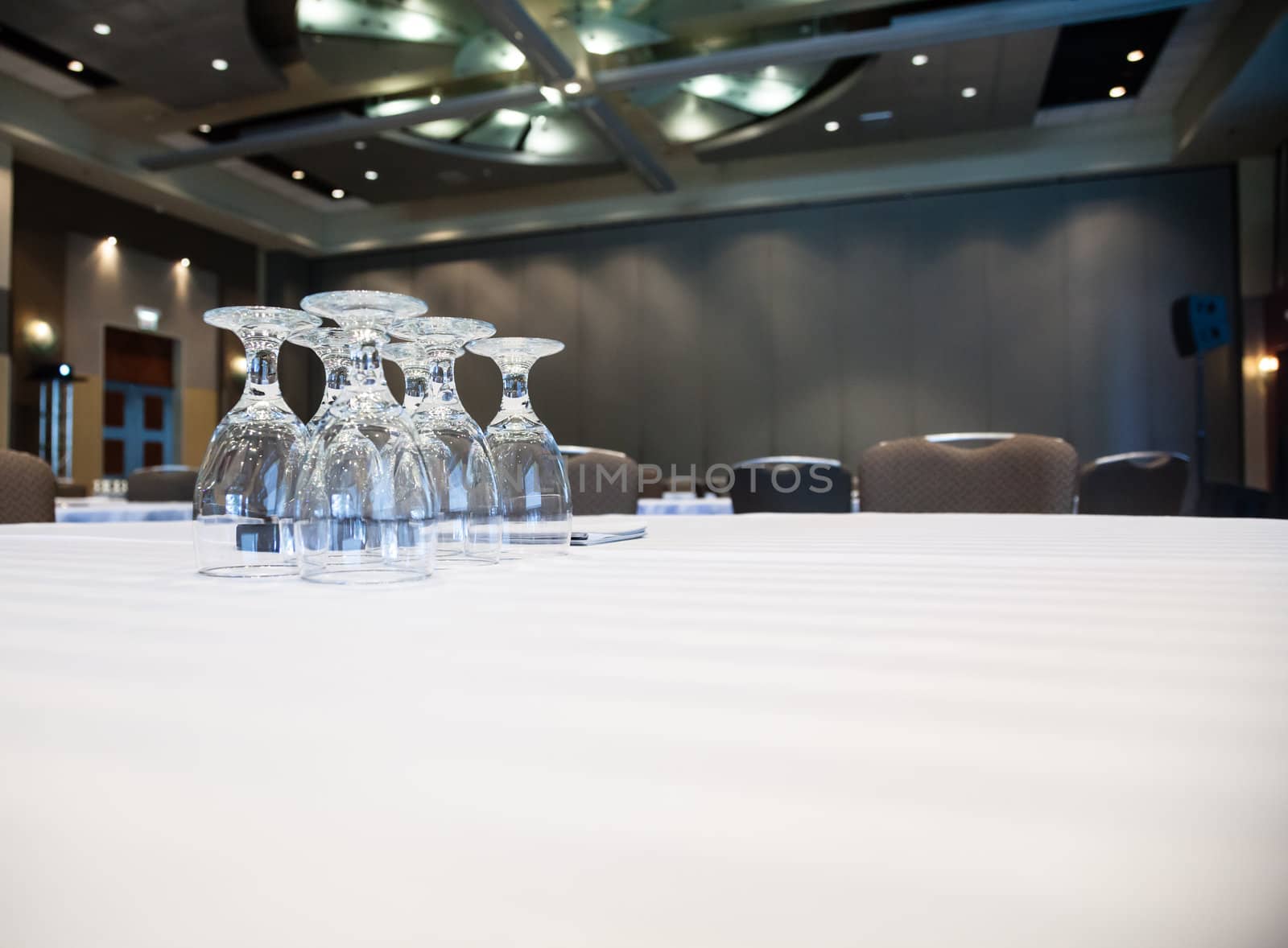 Empty conference room with many tables with white cloths