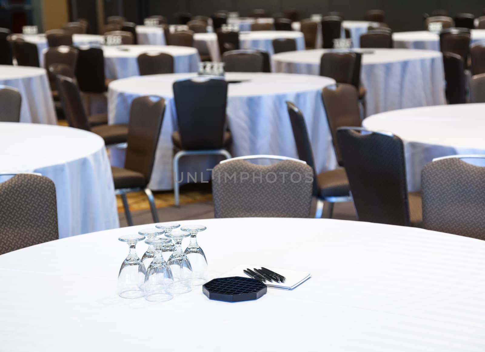 Empty conference room with many tables with white cloths