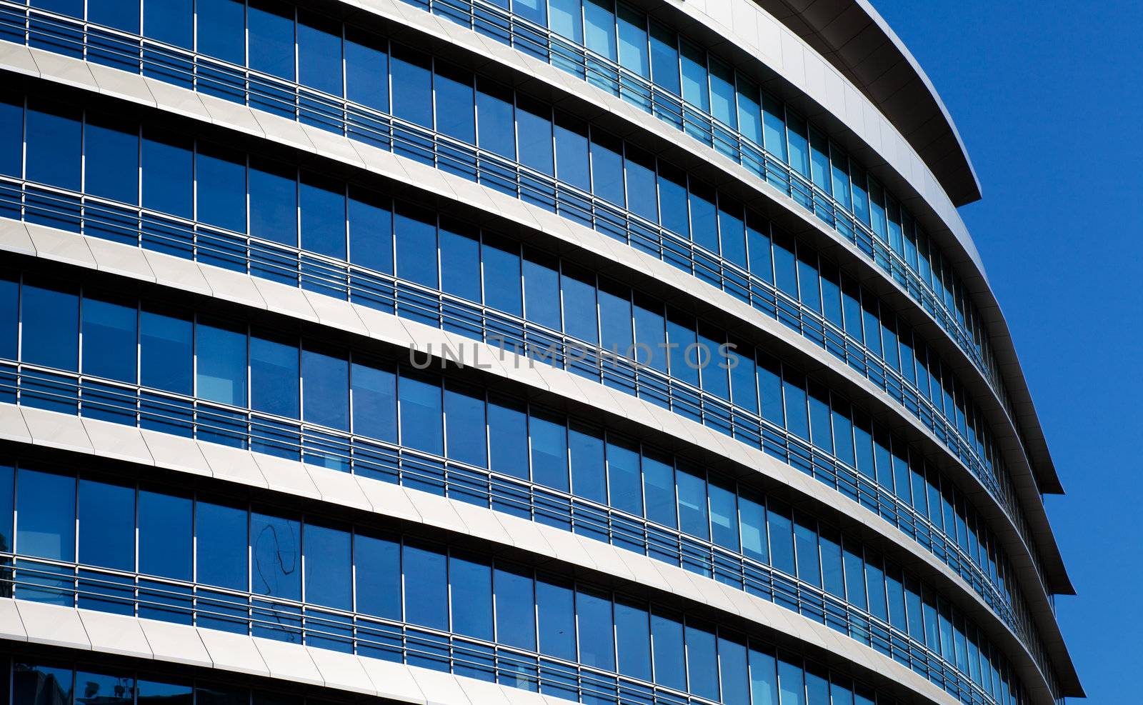 Windows of contemporary business tower over sky background