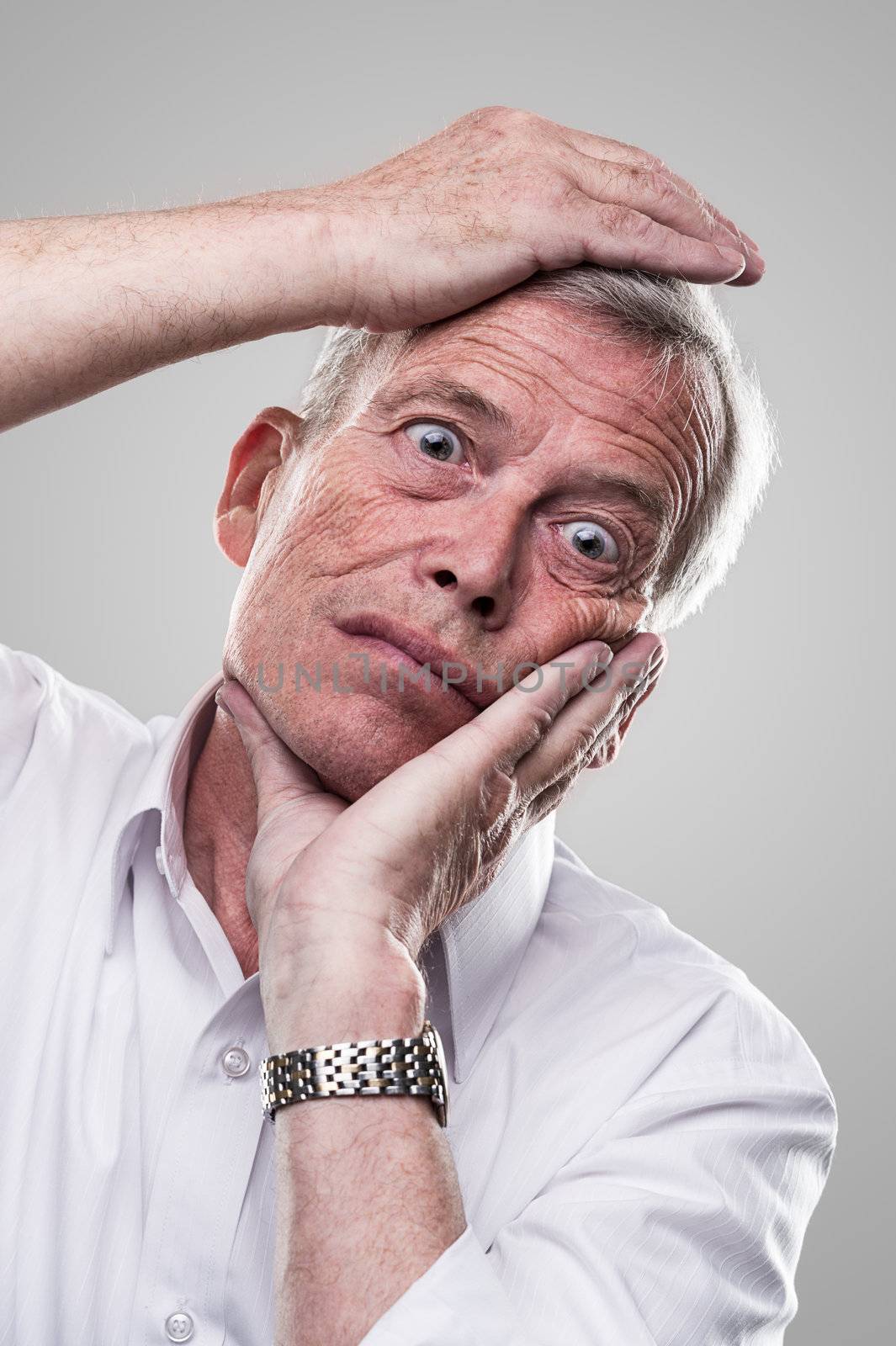 Elderly man puts his head in place