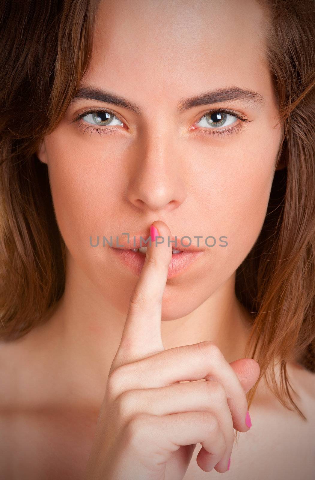 Womanl with her finger over her mouth