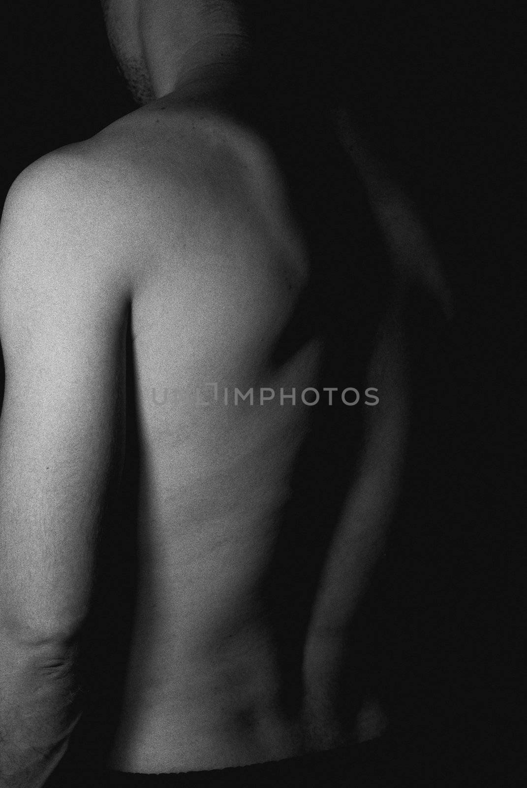 old black and white style of sexy fit naked male body on black background low key