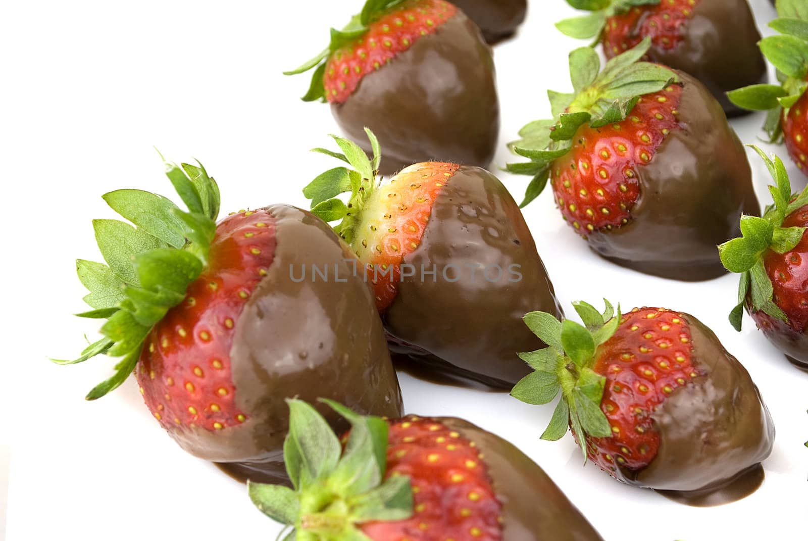 delicious strawberries covered with chocolate in a white plate