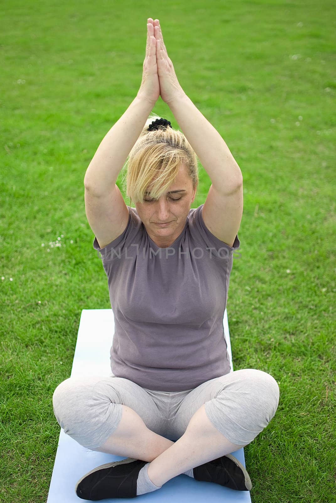 middle aged woman keeping fit with exercises in a park