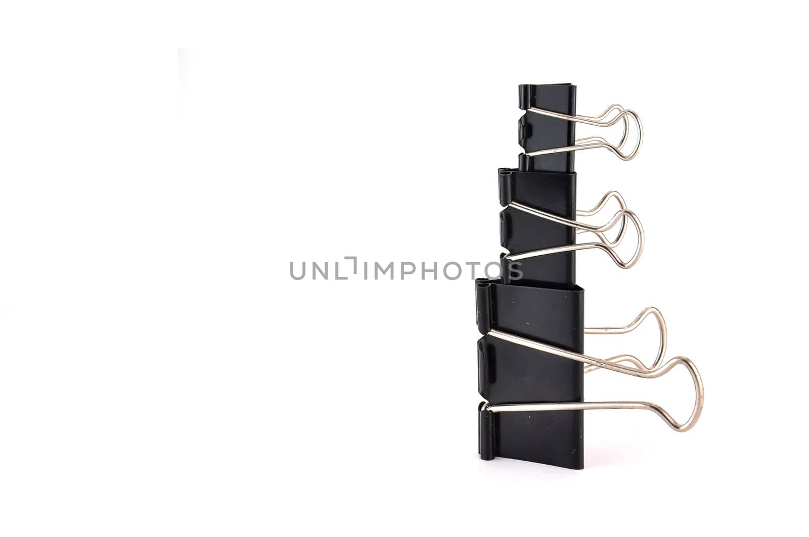 Black paper clips on white background