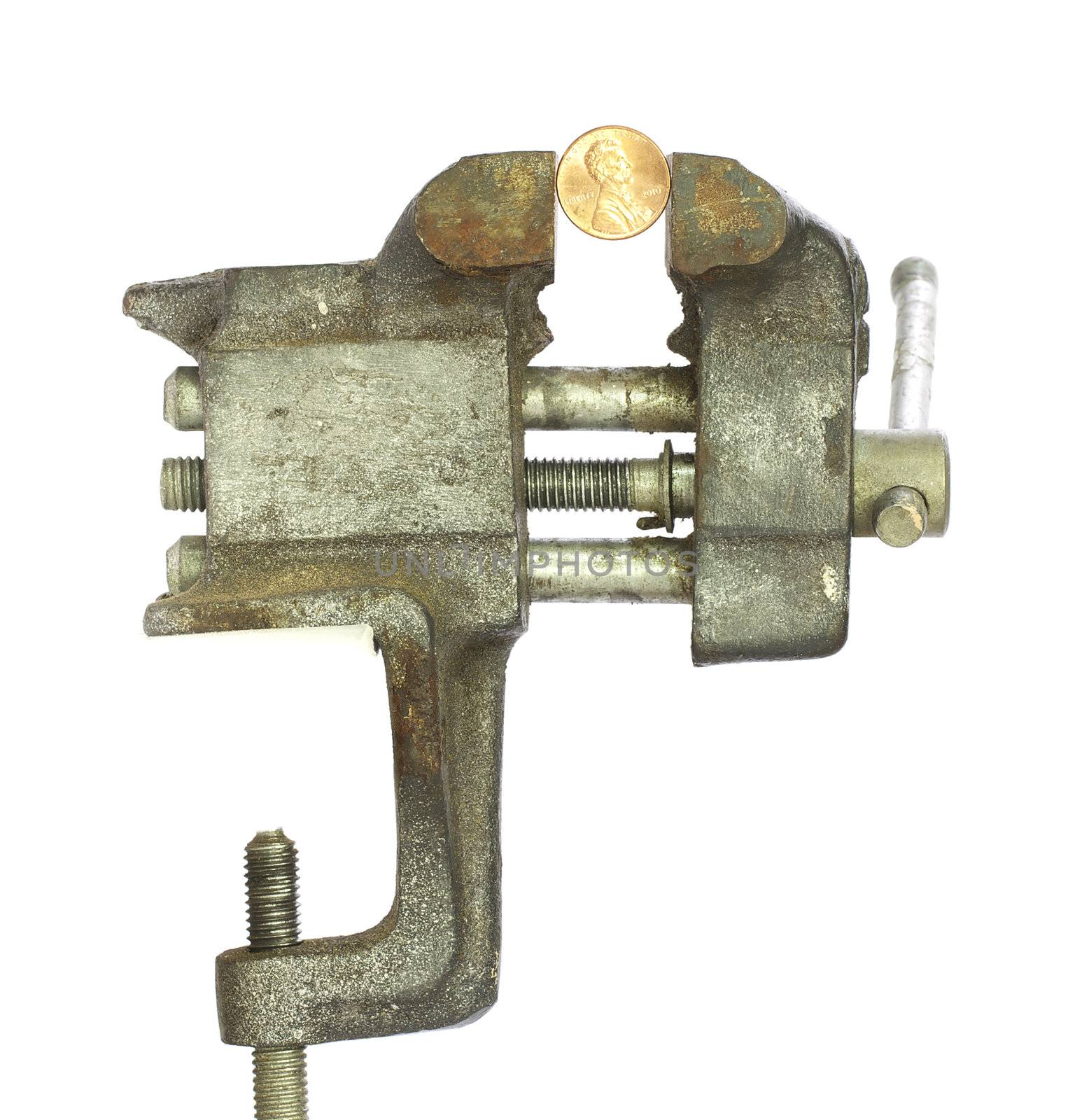 Penny squeezed tightly in a metal bench vice