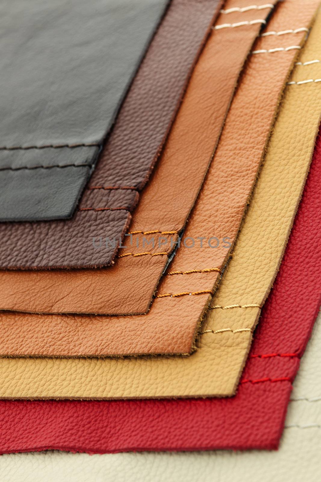 Natural leather upholstery samples with stitching in various colors