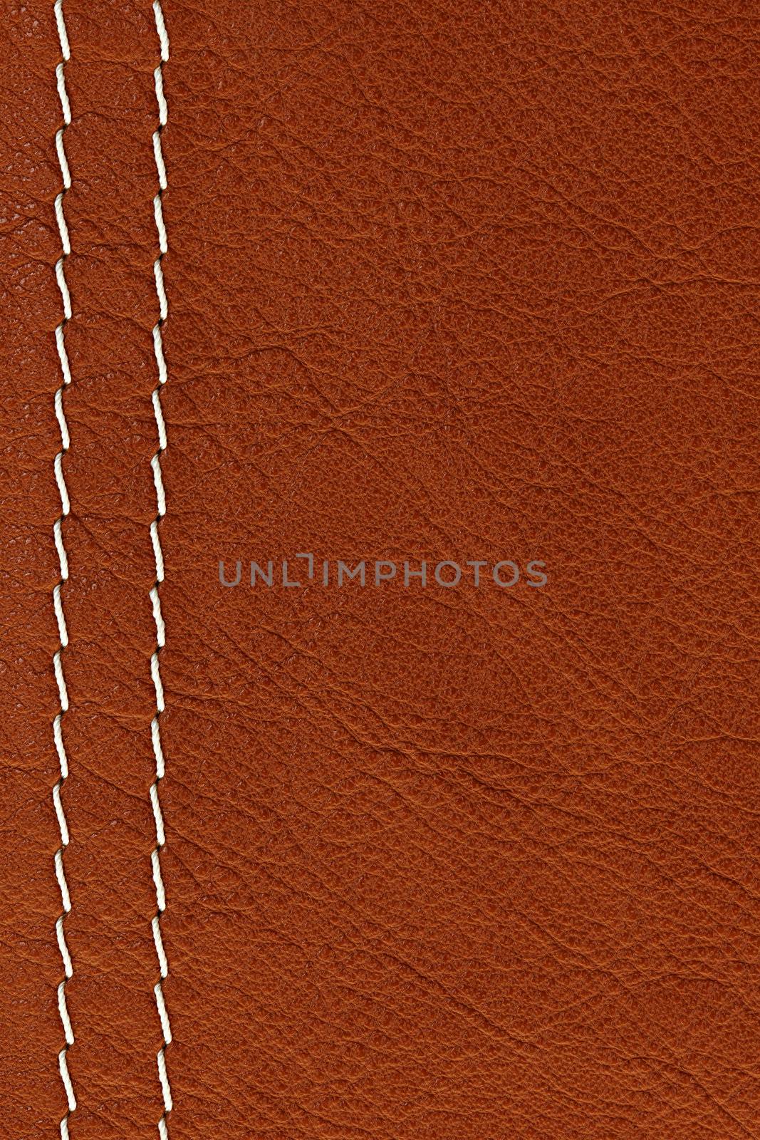 Leather background in brown with white stitches