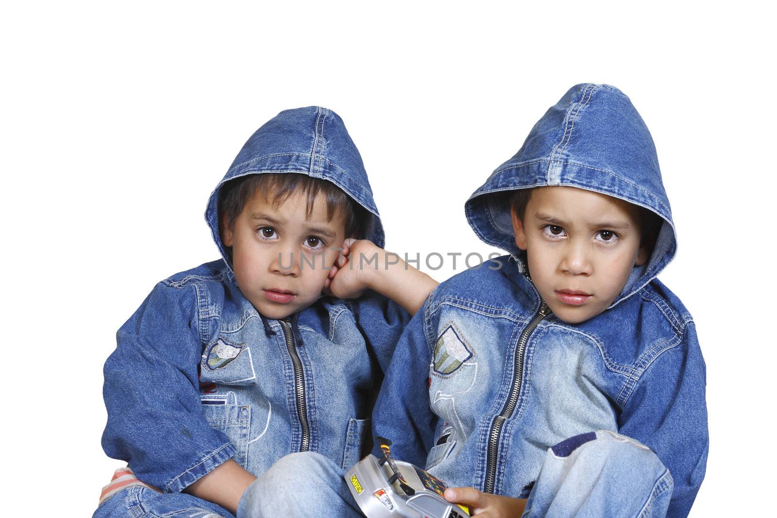 little twin brothers in dzhinsovyhkurtkah isolated on a white background