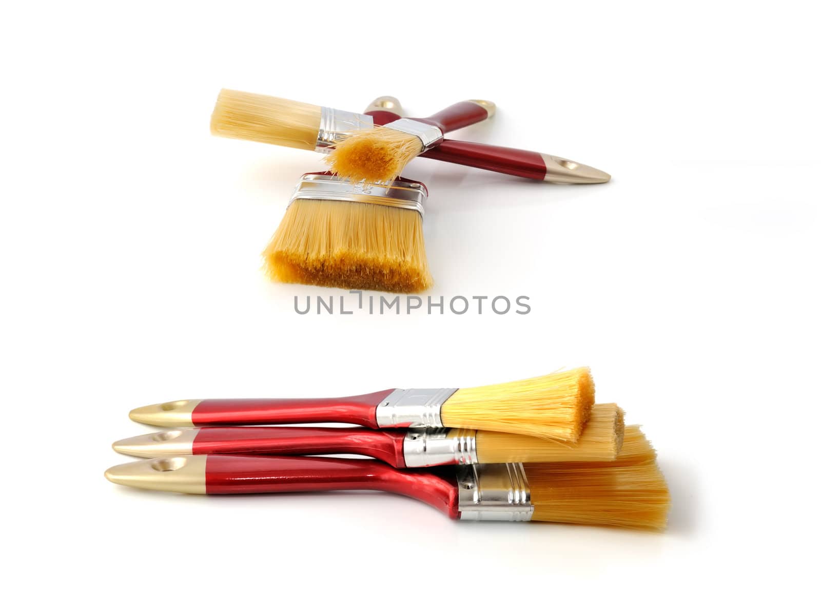 Three clean paint brushes stacked on each other isolated


