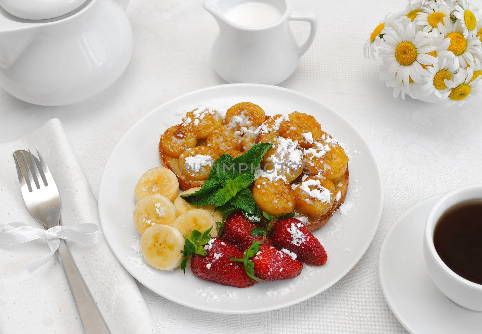 French toast with syrup and a banana with powdered sugar by Apolonia
