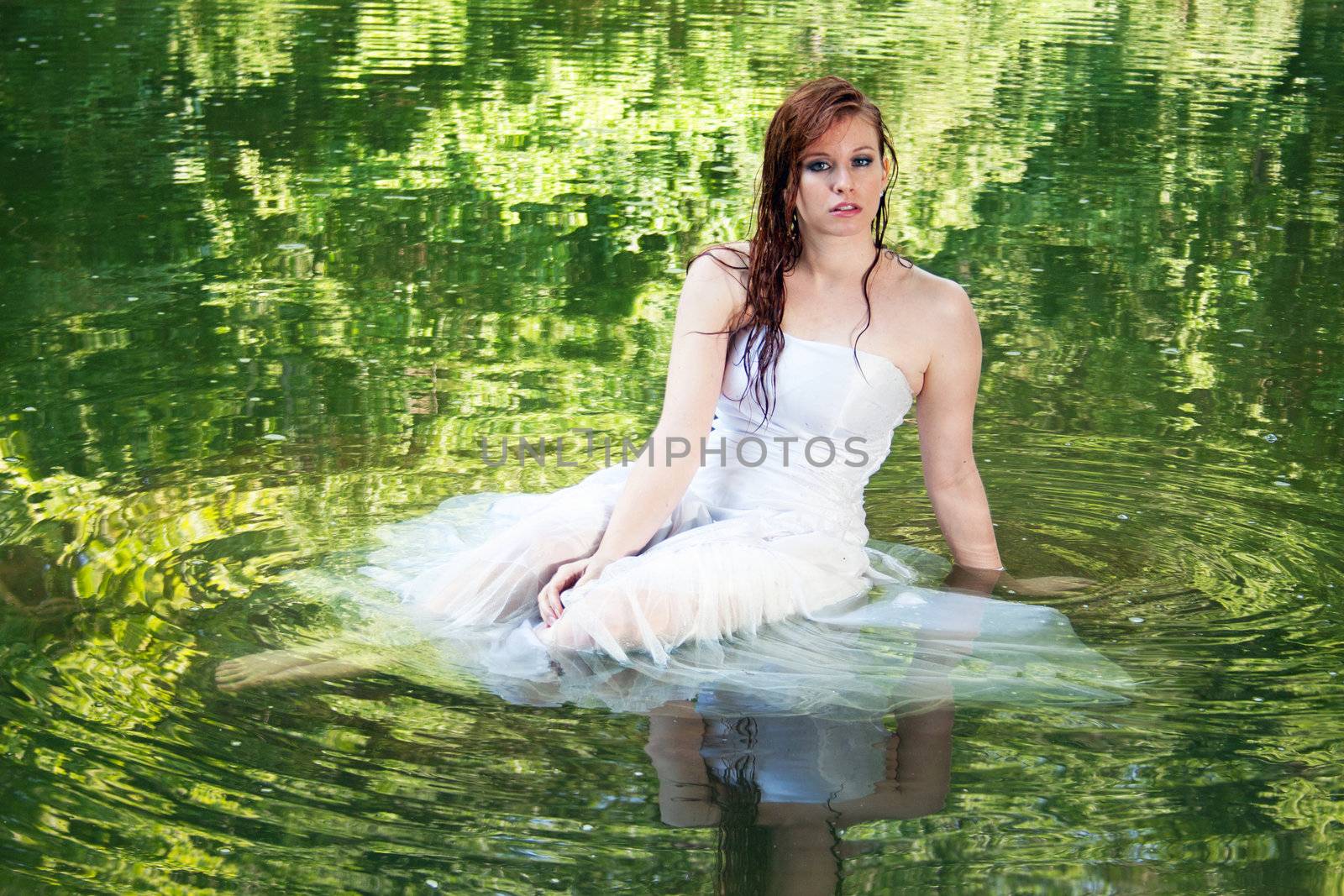 A woman appearing to float in green water