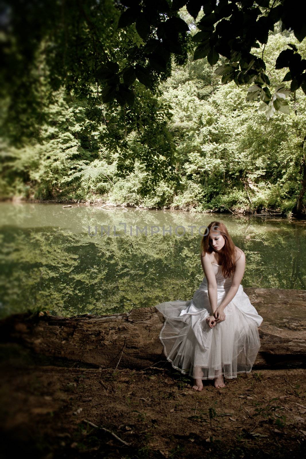 A depressed bride sitting on a log