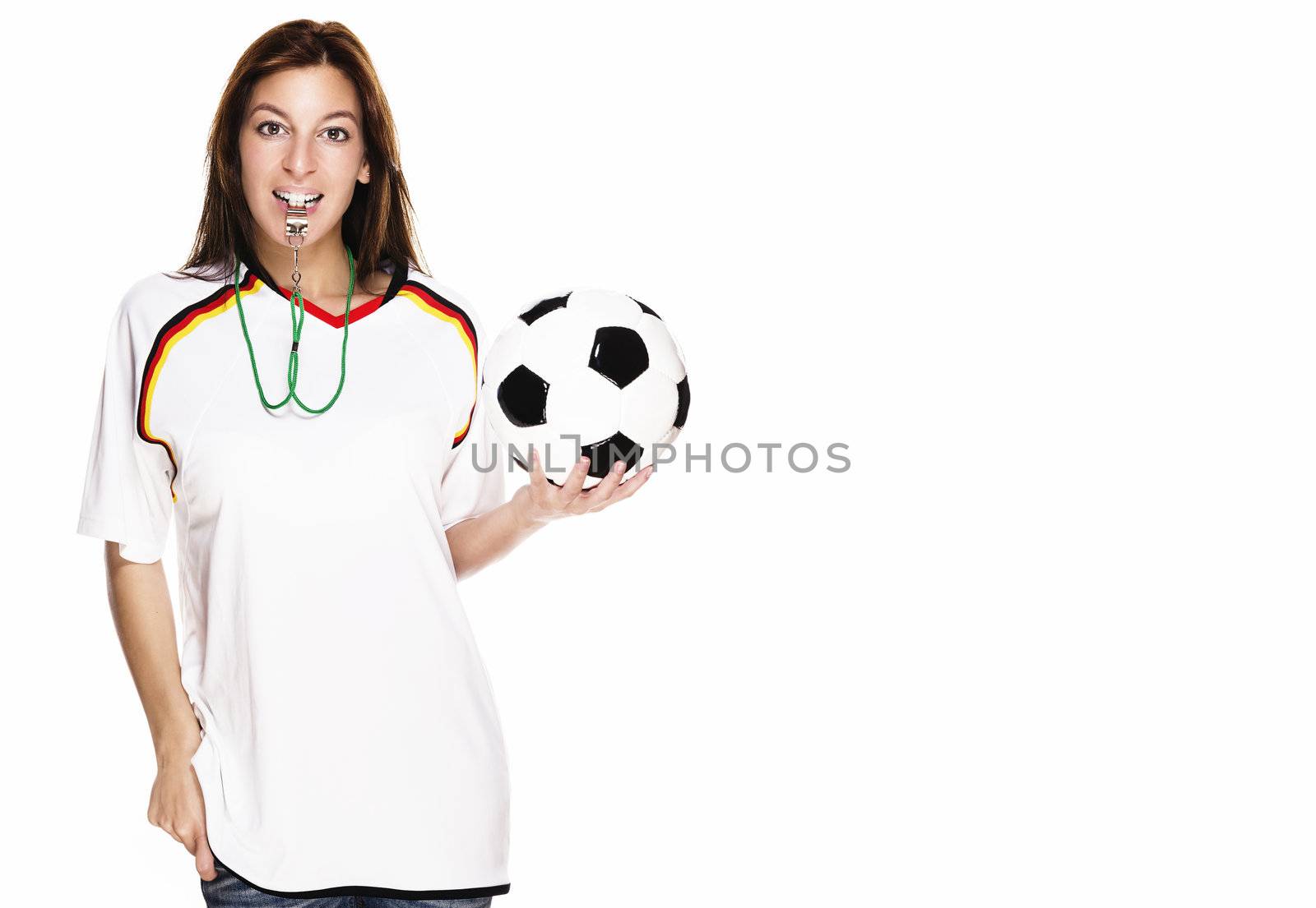 beautiful woman with a whistle wearing football shirt and holding football on white background