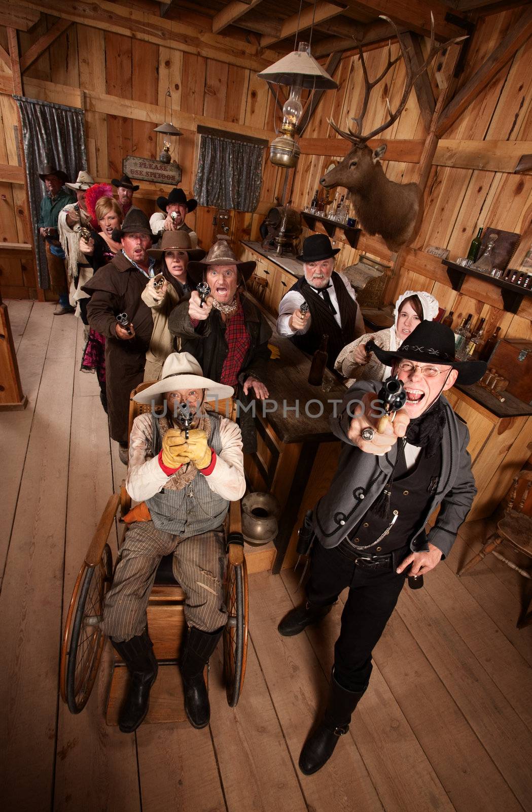 Rowdy customers in old west saloon firing their guns