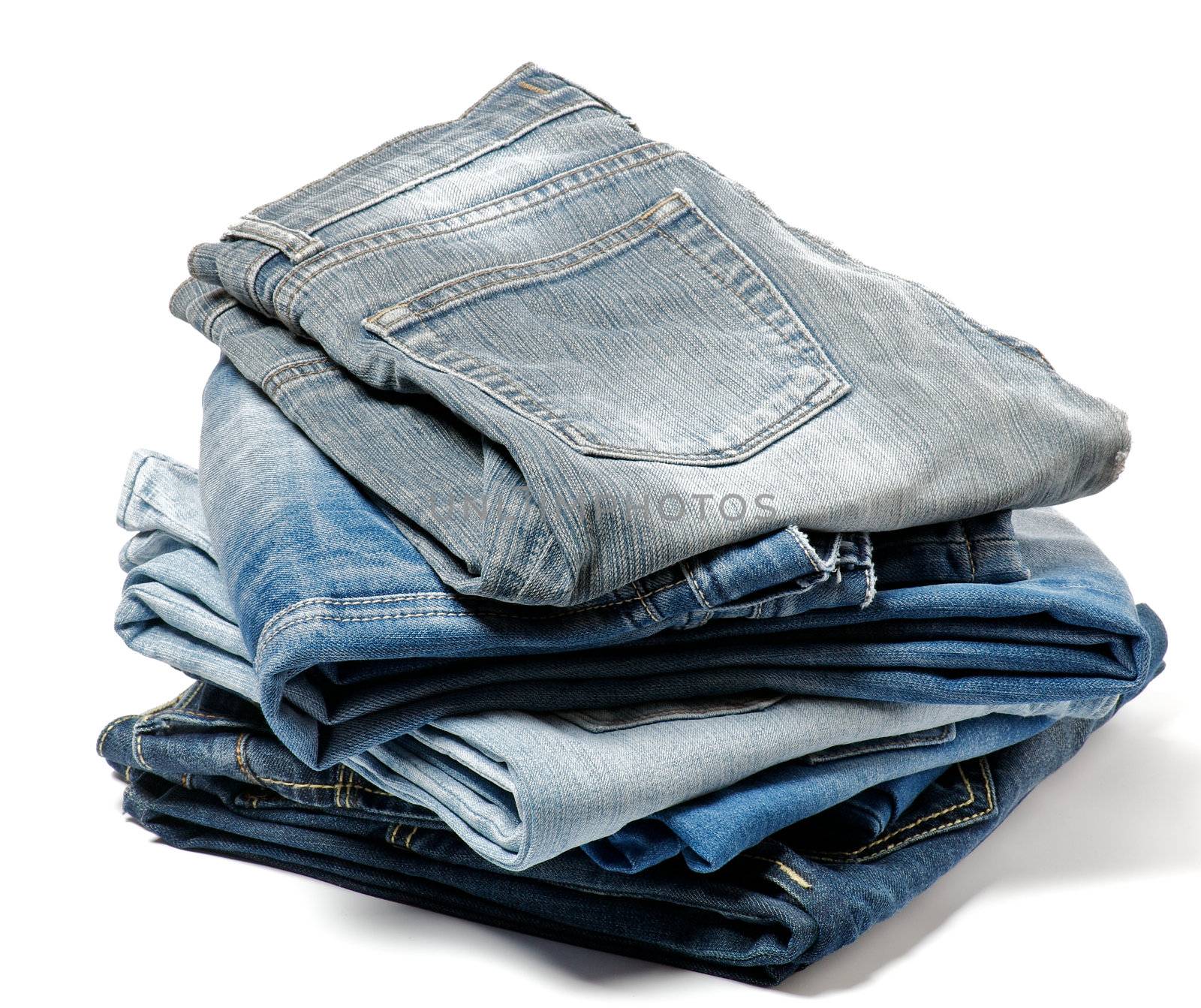 Stack of Folded Old Blue Jeans isolated on white background