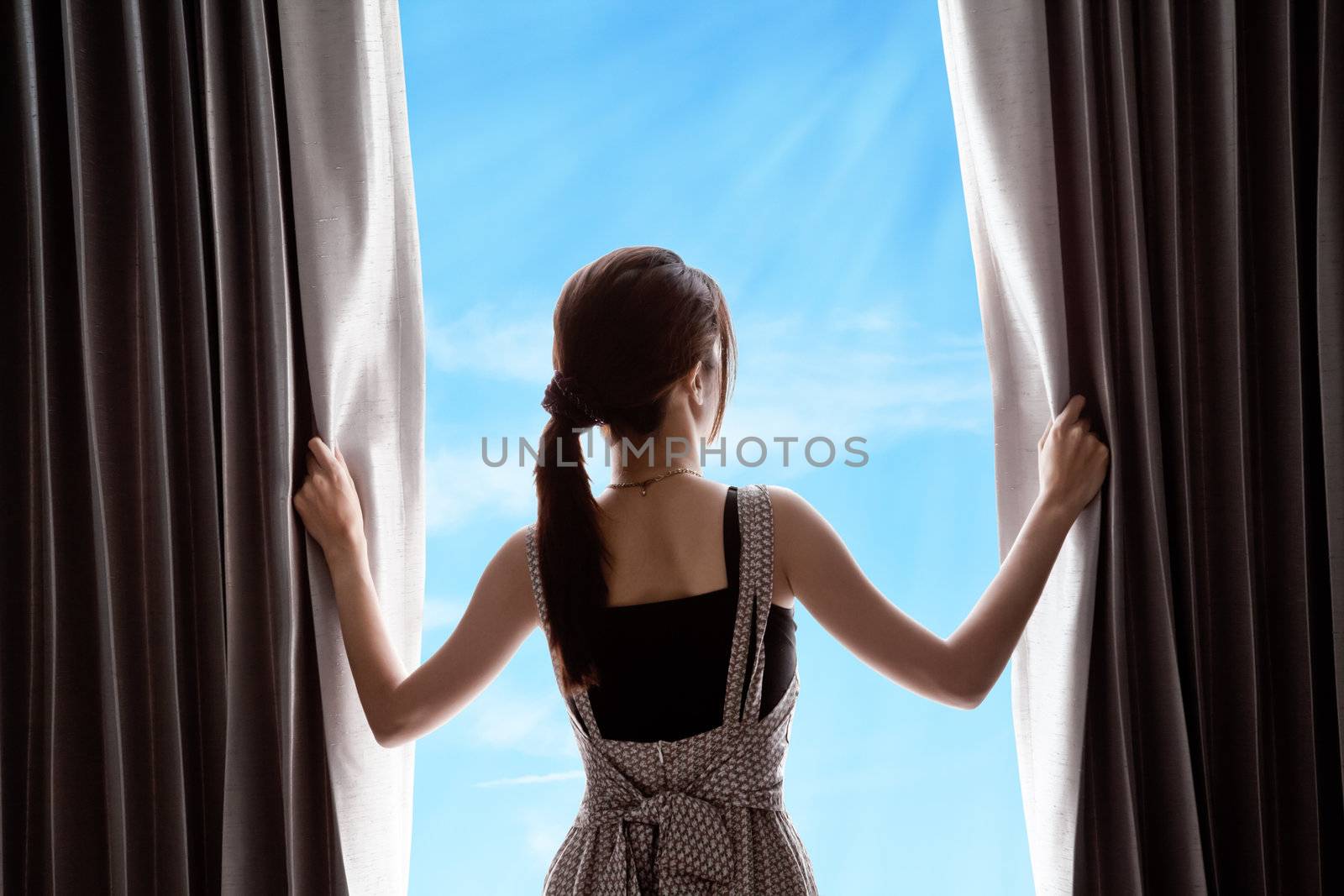 young woman opening curtains and blue sky by FrameAngel