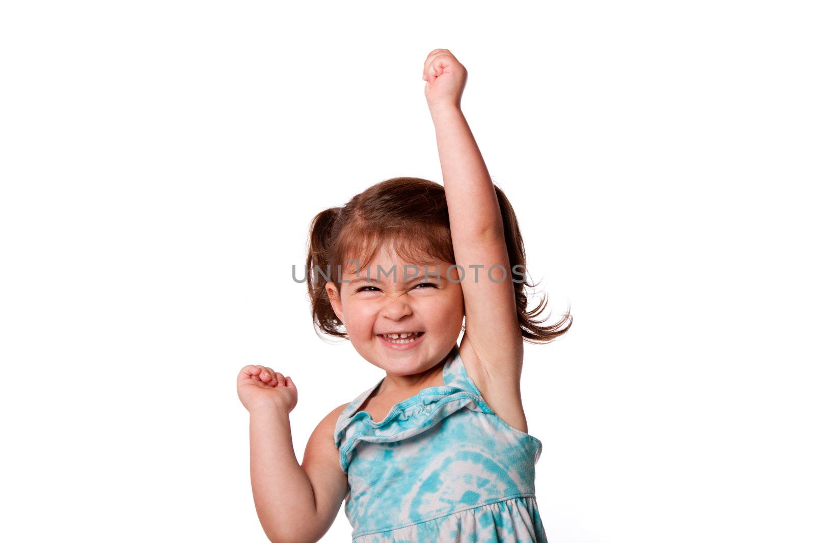 Cute beautiful funny happy little toddler girl celebrating with hand up in air, isolated.