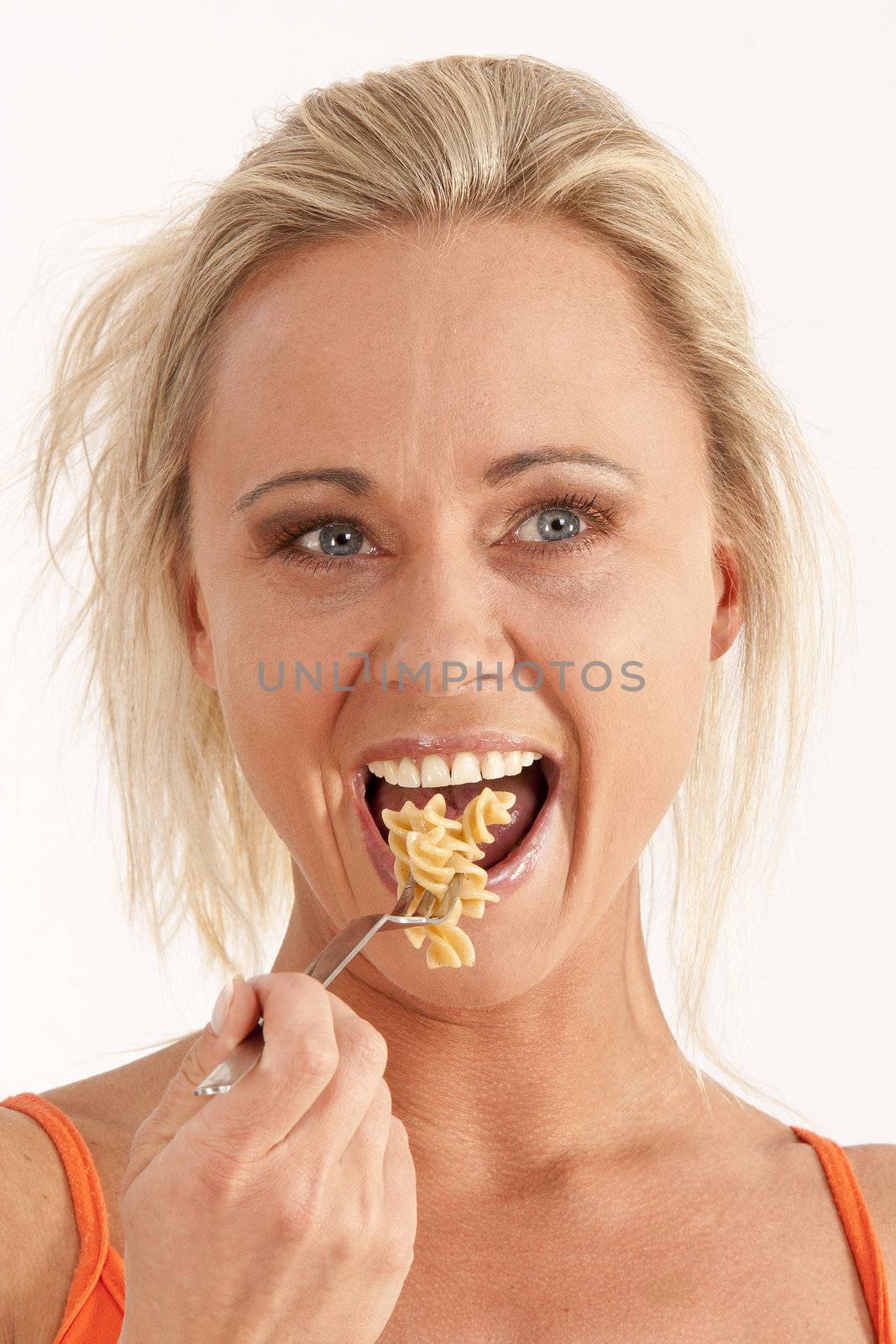 Portrait of a blond woman eating noodles