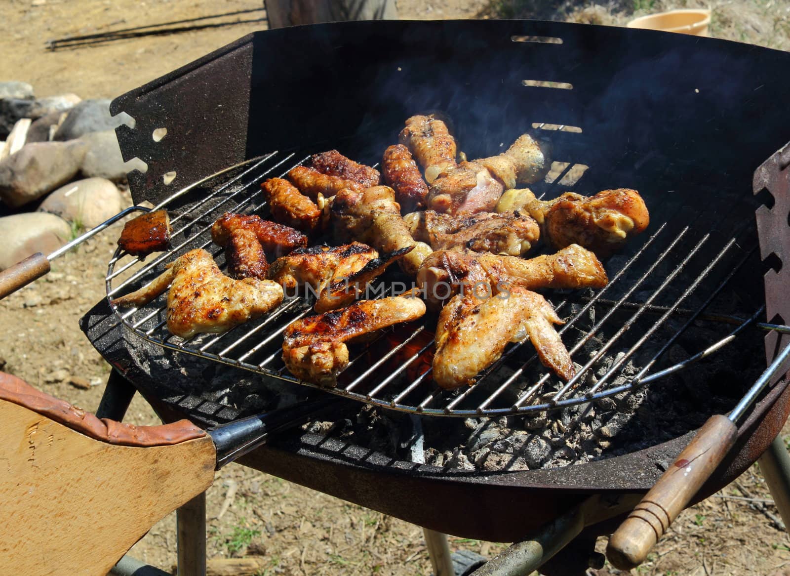 chicken legs and wings roasting on grill