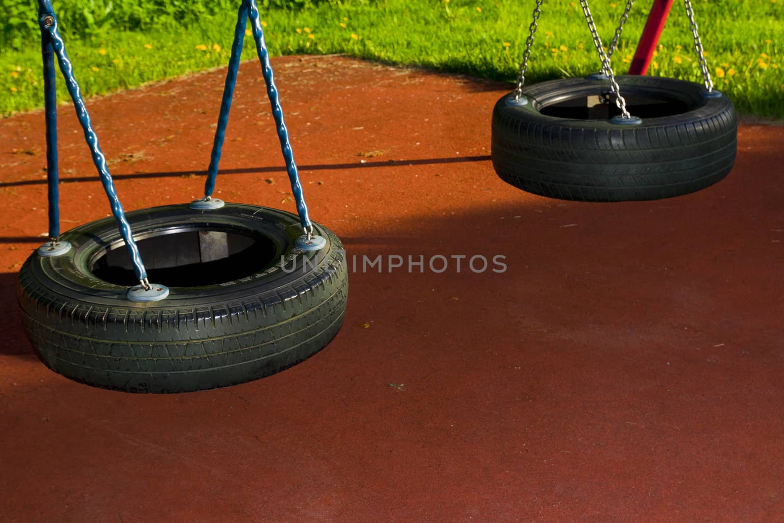 Black tire swings in a playground