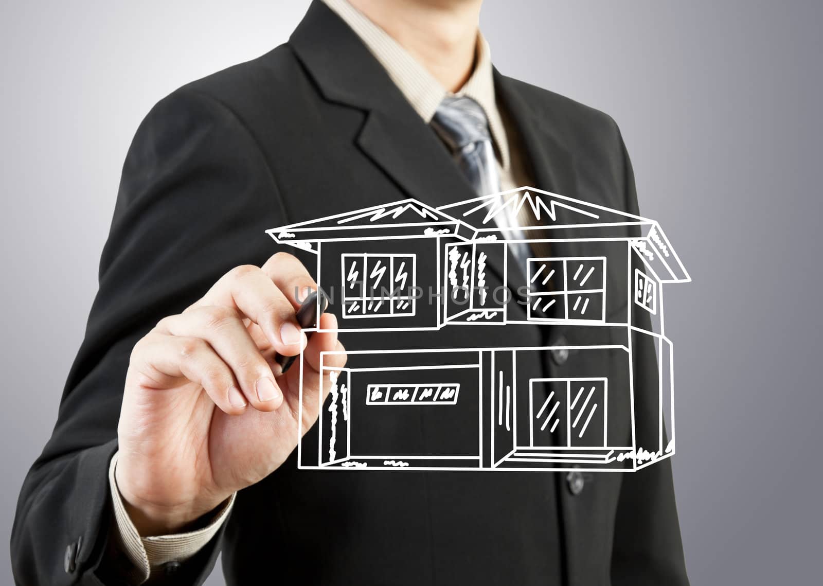 Businessman hand drawing house