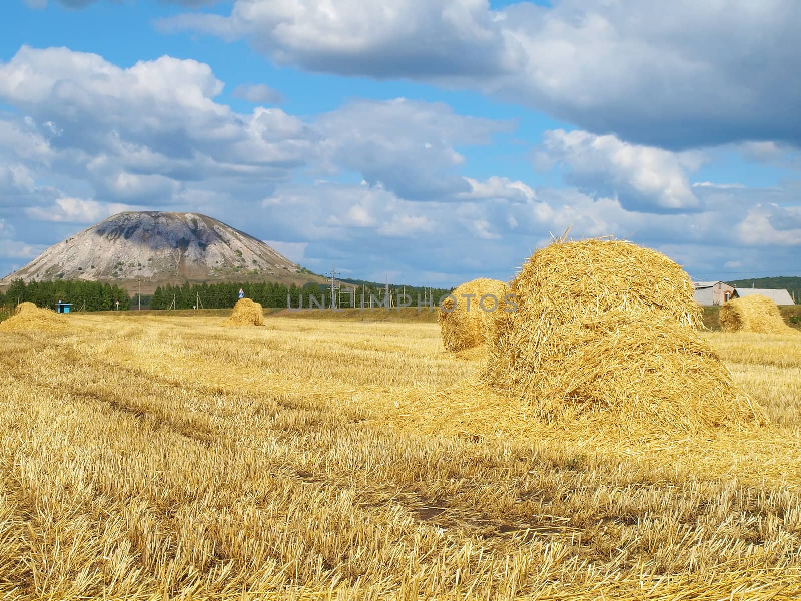 Haystack with high hill on background. by sergpet