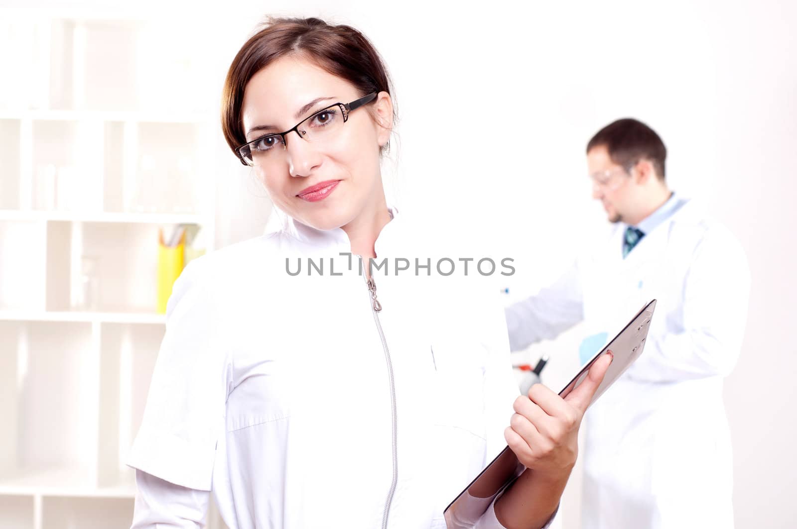 portrait of doctor, holds a tablet in the office