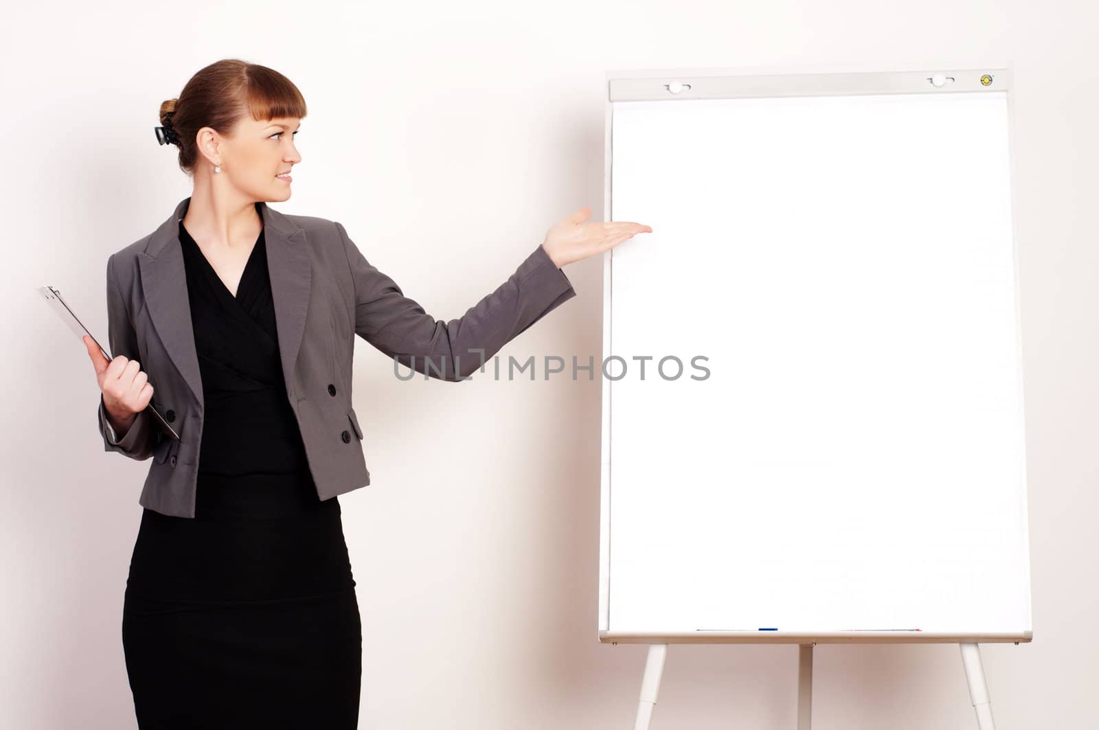 young beautiful woman shows up on a poster with a blank sheet of