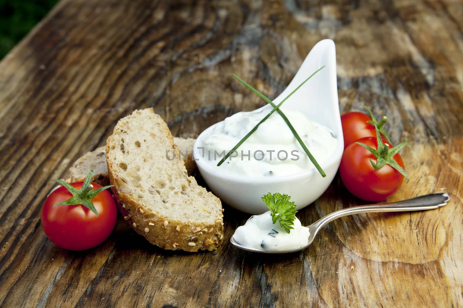 fresh bread with herb curd dinner on wooden background