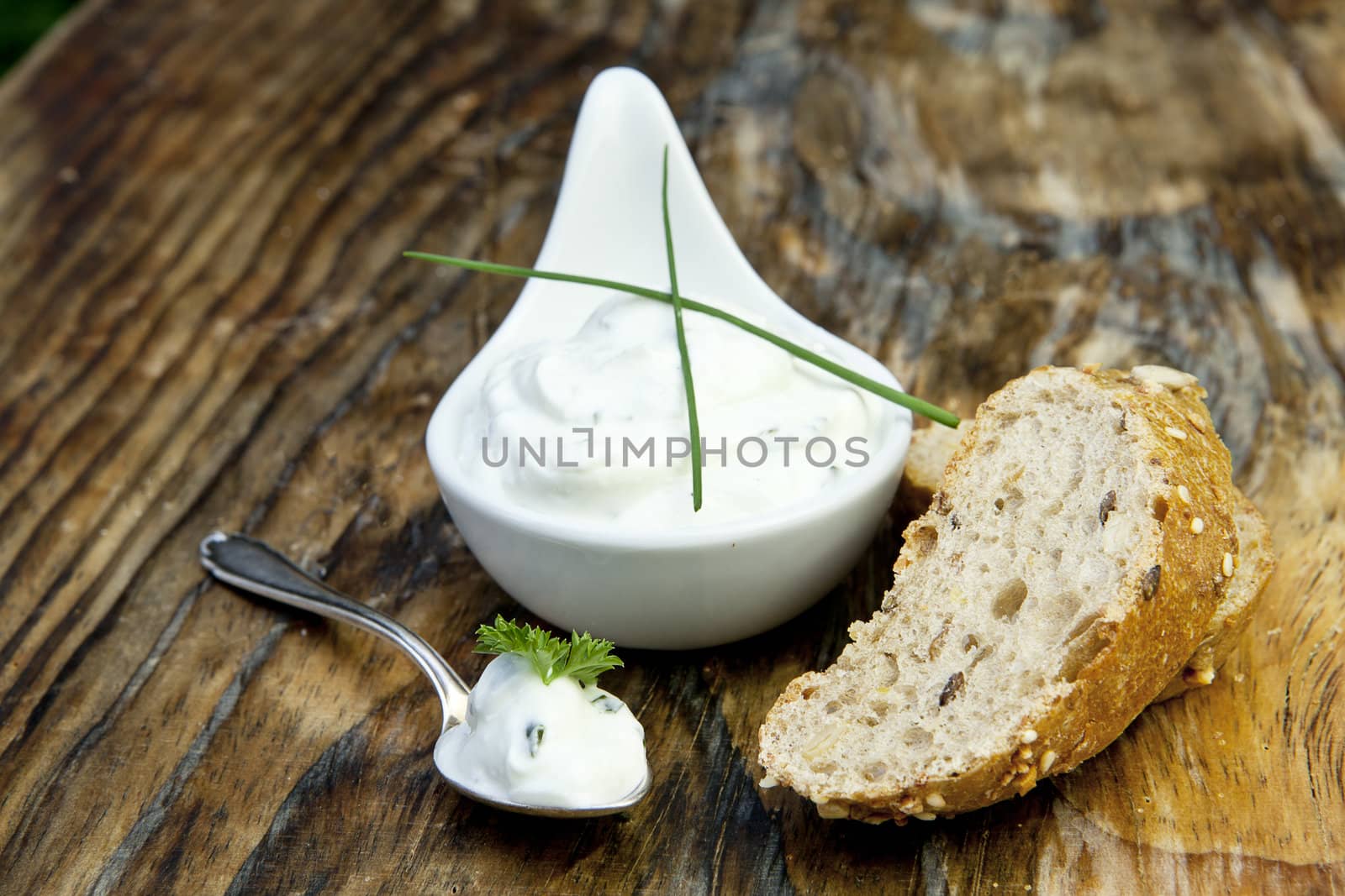 fresh bread with herb curd dinner on wooden background