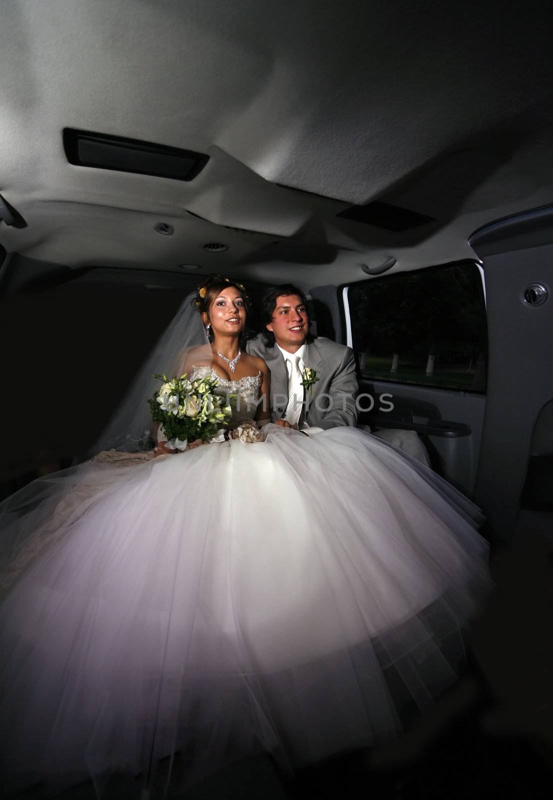 Newly-married couple in car