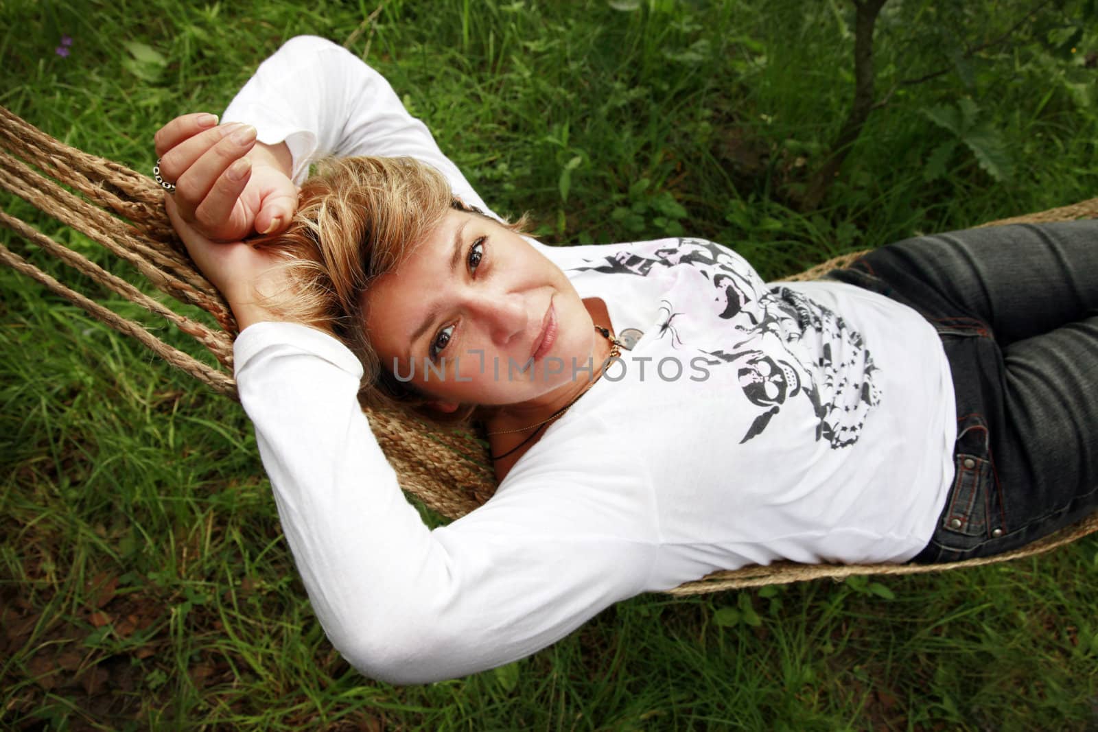 The woman enjoys laying in a hammock